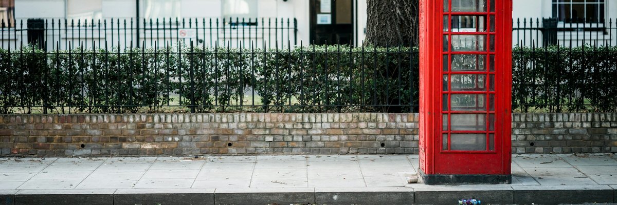 ロンドンの通りに立つ赤い電話ボックス